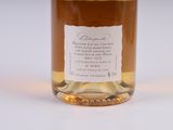 a bottle of whiskey sitting on a white surface