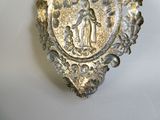 a silver plate with a picture of a woman and a child on it