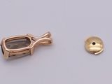a pair of scissors and a gold button on a white surface