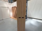un grand objet en bois dans une pièce aux murs blancs