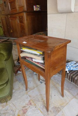 a small wooden table with a book on top of it