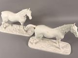 two figurines of horses standing on top of each other
