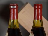 two bottles of wine sitting next to each other on a table