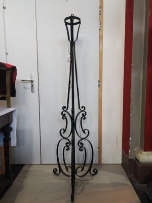 a coat rack that is standing in the corner of a room