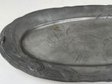 a silver plate with a bird on it
