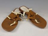 sandales en cuir beige avec des lacets blancs et un nœud sur la pointe