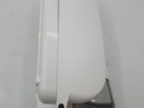 a white toilet that is on a white surface
