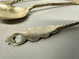 two spoons and a spoon with a handle on a table
