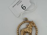 a close up of a gold ornament with a horse on it