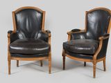 pair of black leather armchairs with wood frame and arms