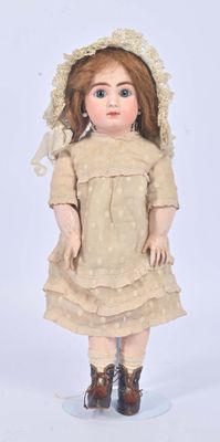 a small doll that is wearing a dress and hat