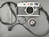 a black and white photo of a camera and a camera case