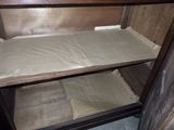 a wooden shelf with a mattress on top of it