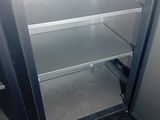 an empty refrigerator in the corner of a room