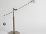 a close up of a lamp on a stand with a ball hanging from it