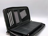 an image of a black wallet with a zipper on the inside of it
