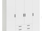 a close up of a white wardrobe with drawers and drawers