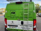 a green and white van parked on the side of the road
