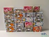many boxes with different designs on them sitting on a table