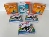 four boxes of twister toys sitting on a white surface
