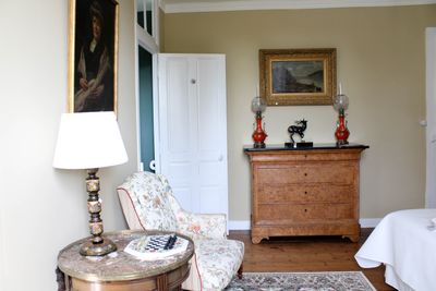 une pièce dans laquelle se trouvent un lit, une chaise et une commode