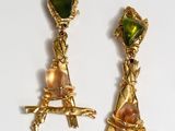 two pairs of gold earrings with green and pink stones on them