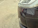 a close up of a car ' s headlight on a parking lot