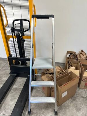 a stack of boxes on the floor next to a forklift