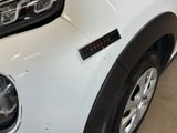 a close up of a white car with a sticker on the front of it