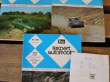four books on a wooden table with a car in the background