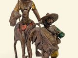 statue représentant une femme à cheval, avec un homme sur le dos