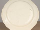 a white plate sitting on a wooden table