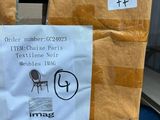 a sign on the back of a chair that is wrapped in brown paper