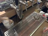 a person that is pouring a drink at a bar