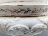 a close up of a white vase with a decorative decoration