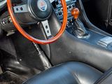 a steering wheel and dashboard of a sports car