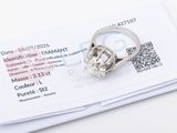 a diamond ring sitting on top of a piece of paper
