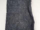 a close up of a gray scarf on a white surface