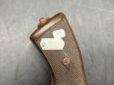 an old gun with a tag on it sitting on a table