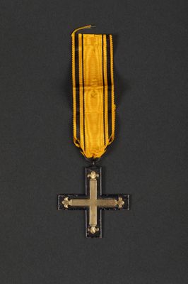 an image of a medal with a cross on it on a black background