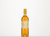 an empty bottle of wine sitting on top of a table