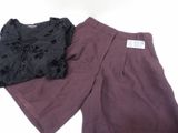 two pieces of clothing sitting on top of a table next to each other