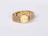 an image of a gold wrist watch with a chain around it