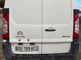 the back of a white van parked in a parking lot