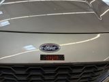 a close up of the front of a car with a badge on it