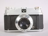 a black and white photo of a camera on a white surface