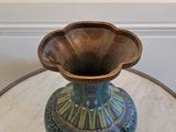 a vase that is sitting on a table in a room