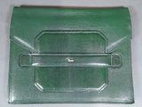 green leather wallet with a metal clasp on a white surface