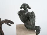 two sculptures that are sitting on top of a table