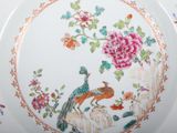 a plate with a bird and flowers painted on it